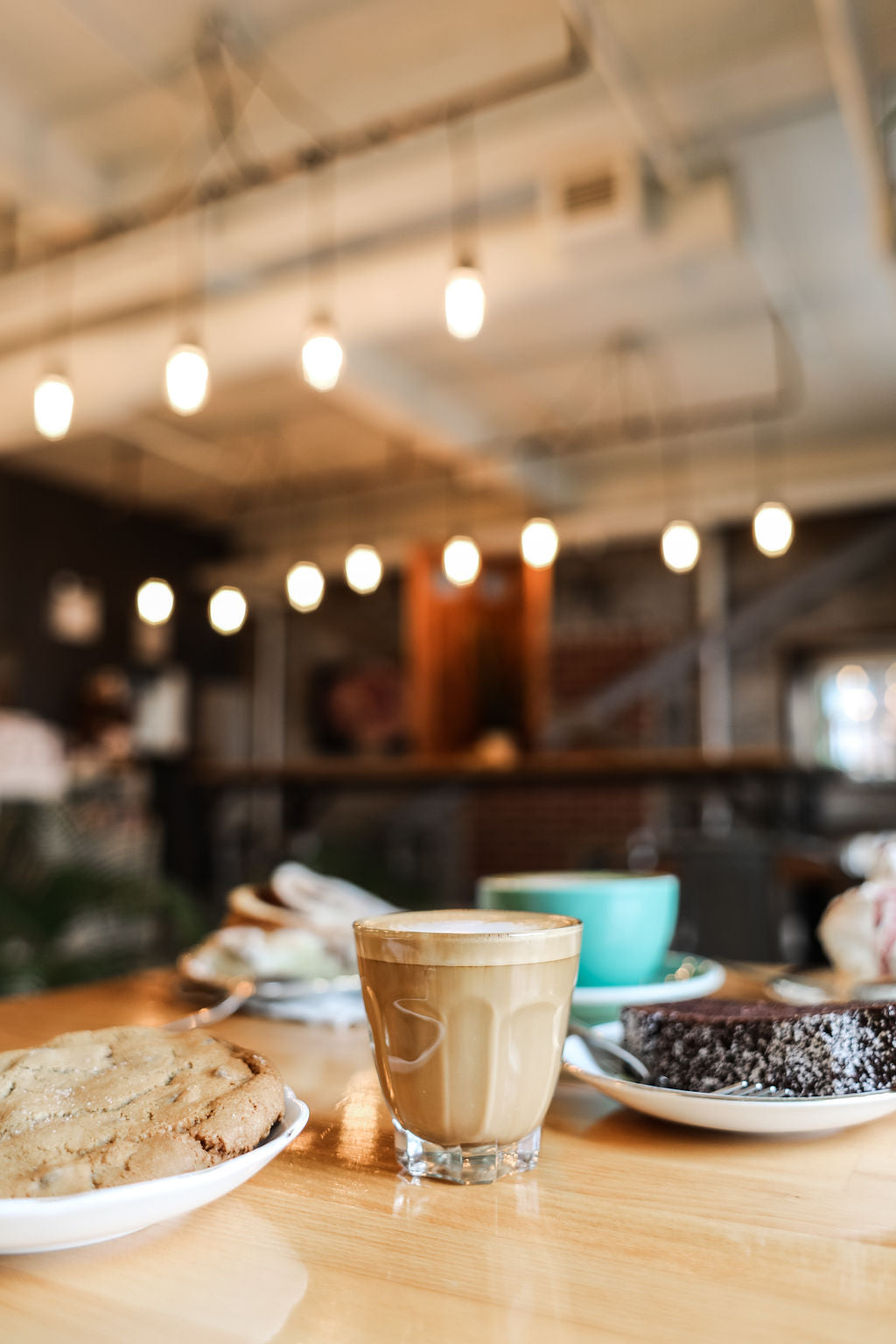 A picture showing coffee, breakfast and a cookie served at the King St location of Juniper cafe.