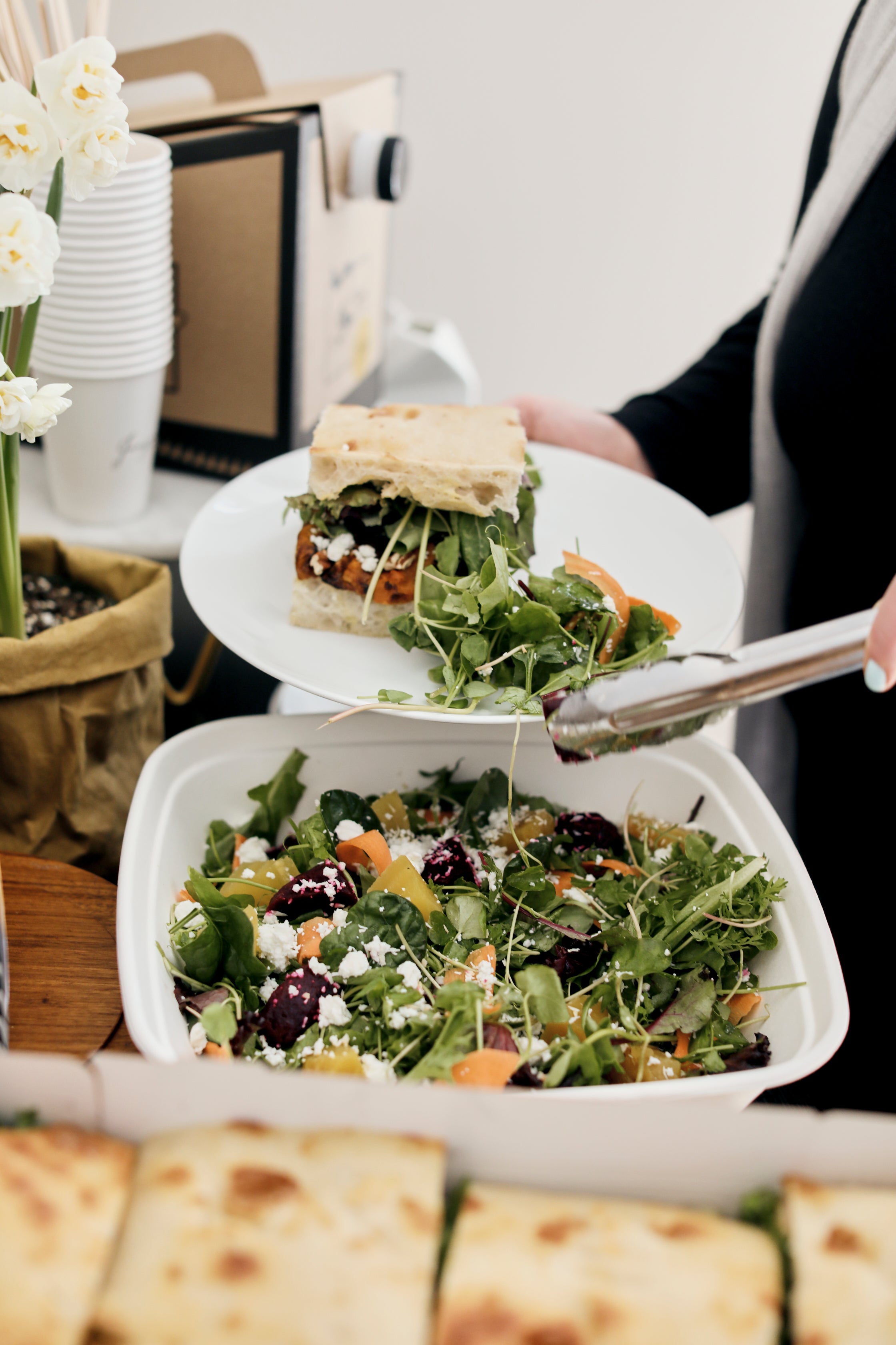 An image showing a serving of a delicious sandwich with salad. 