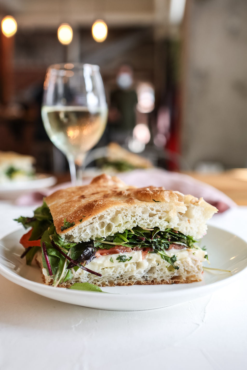 A picture of sandwich served with white wine at Juniper Cafe.